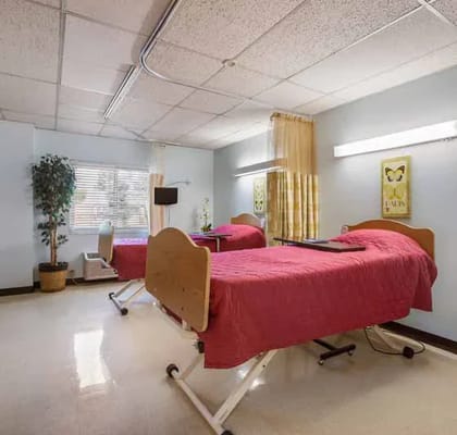 Two twin beds in a well-lit resident room