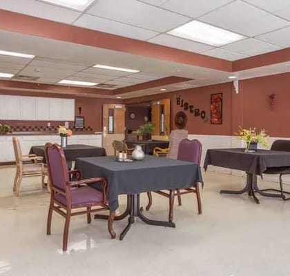 Dining area with tables and chairs in warm tones