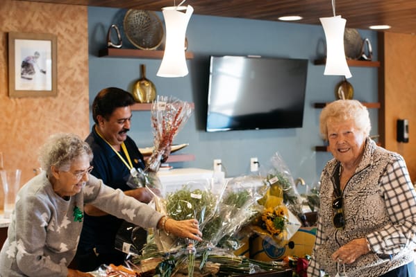 Residents participating in a flower arranging activity