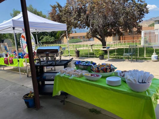 Outdoor event setup with food and seating