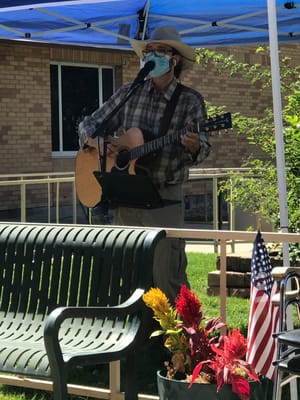 Musician performing outdoors for residents