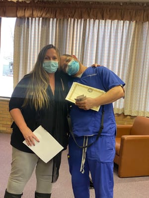 Staff member celebrating with a resident in a common area