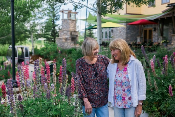 Two residents enjoying a beautiful garden setting