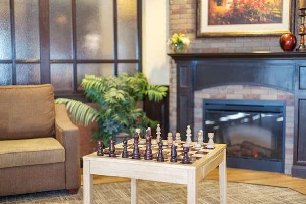 Cozy common area with chess table and fireplace