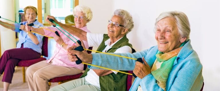 Seniors participating in a group exercise class indoors