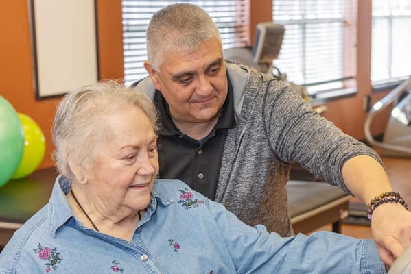 Physical activity session with a resident and staff member