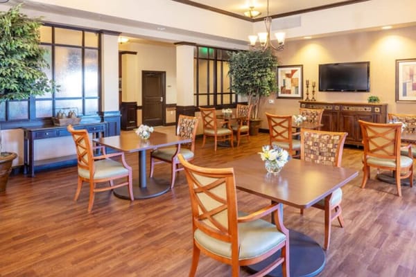 Bright common area with dining tables and seating