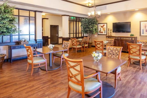 Bright common area with dining tables and seating
