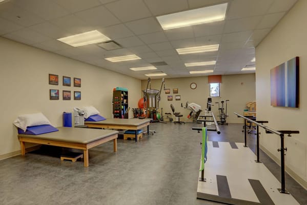 Physical therapy room with equipment and exercise areas