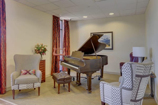 Cozy interior space with a grand piano and seating
