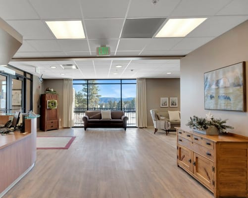 Bright common area with seating and large windows