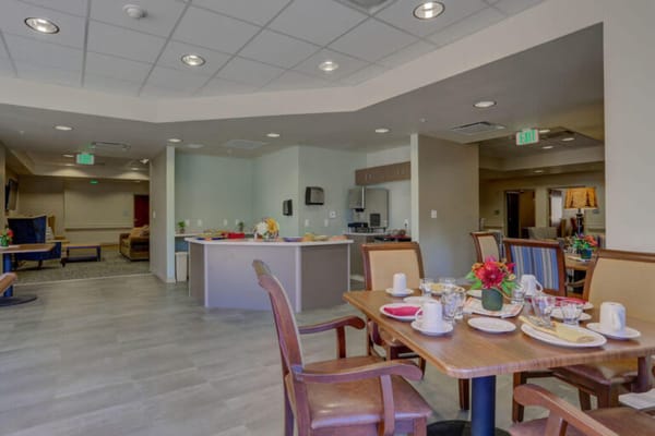 Dining area with neatly set tables and flowers
