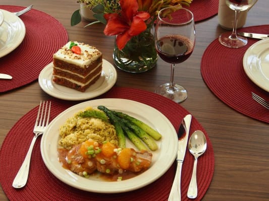 Beautifully plated meal with dessert and wine