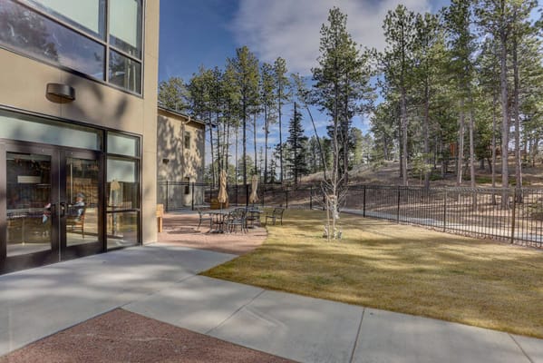 Outdoor seating area next to a modern facility