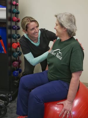 Therapist assisting a resident in a fitness session