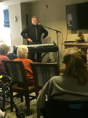 A performer entertaining residents in a common area