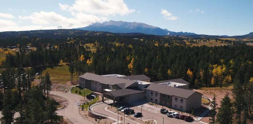 Aerial view of a senior living facility surrounded by mountains