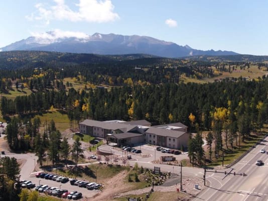 Aerial view of a senior living facility with mountains
