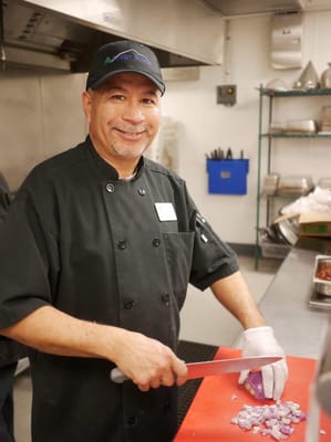 Staff member preparing food in the kitchen