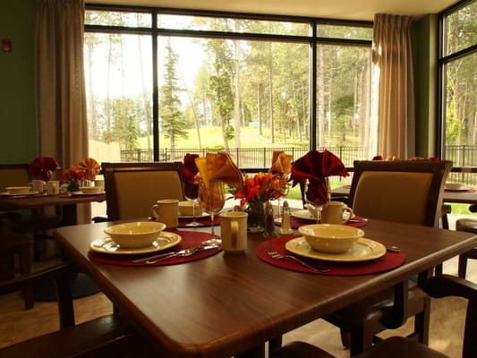 Dining room set for a meal with outdoor view