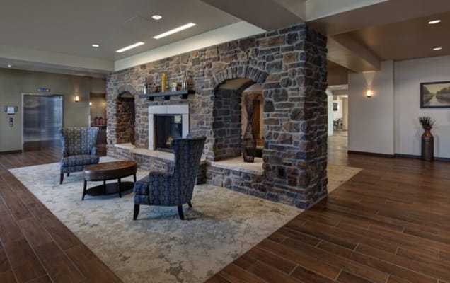 Cozy common area with stone fireplace and seating