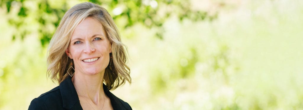 Smiling woman outdoors in a sunny setting