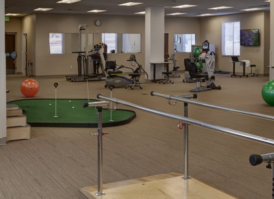 Rehabilitation gym with exercise equipment and therapy area