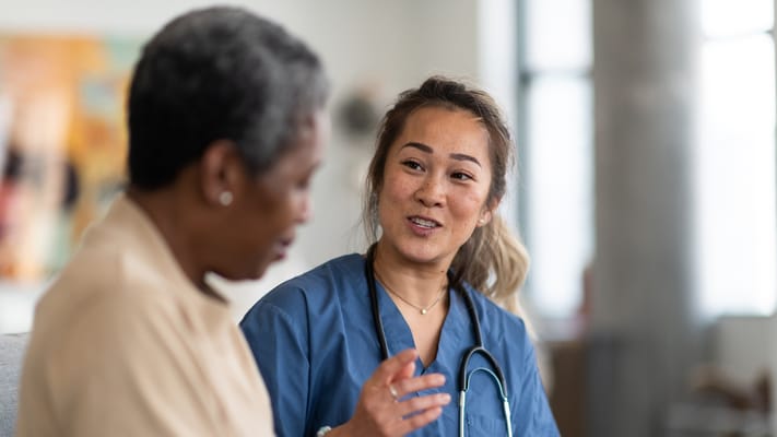 Healthcare professional conversing with a resident