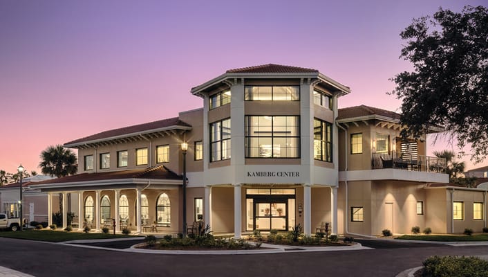 Exterior view of a senior living facility at sunset