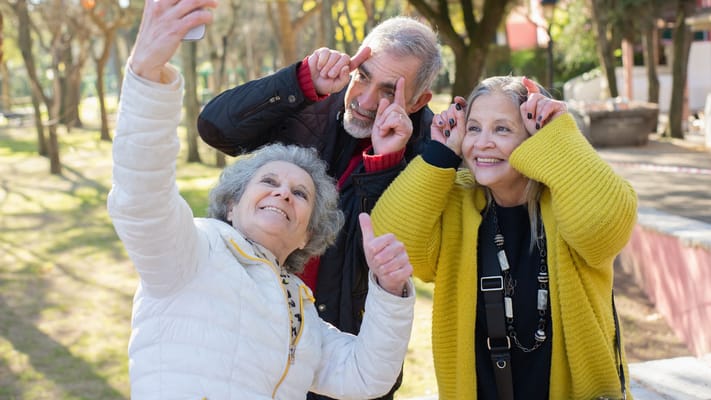 Three residents taking a selfie in a garden