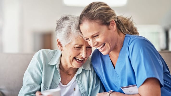 Caregiver and resident sharing a joyful moment