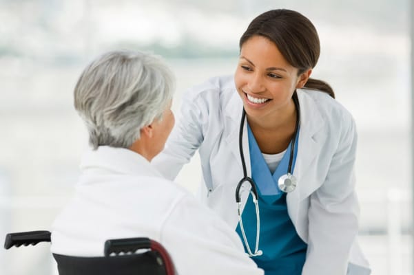 A caregiver warmly interacting with a senior resident