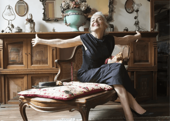A smiling woman in a cozy living room setting
