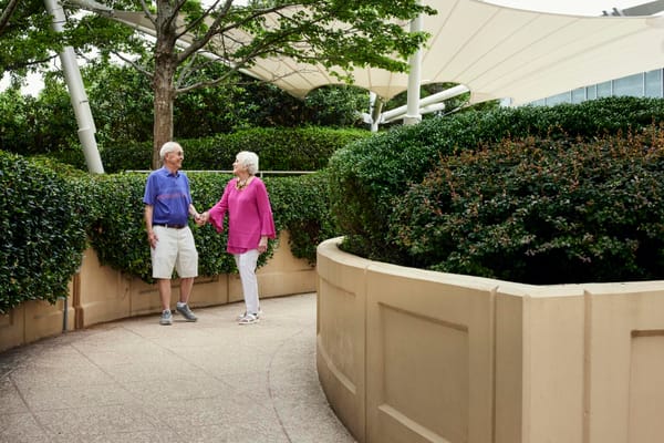 Seniors enjoying a walk in a garden area