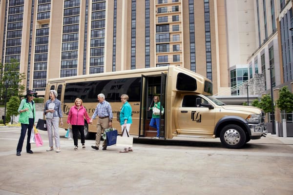 Residents arriving at the facility in a shuttle bus