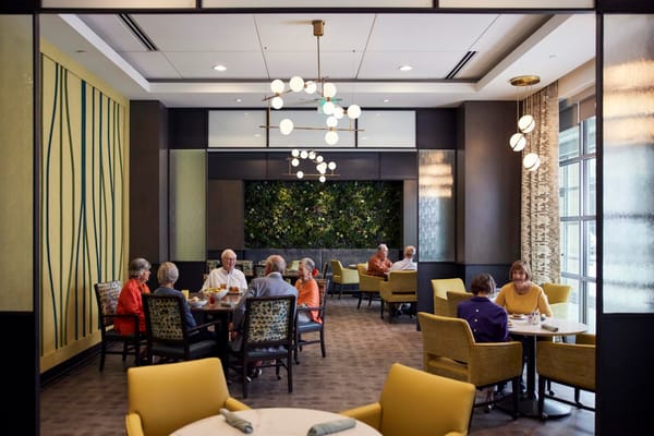 Residents dining together in a bright dining room