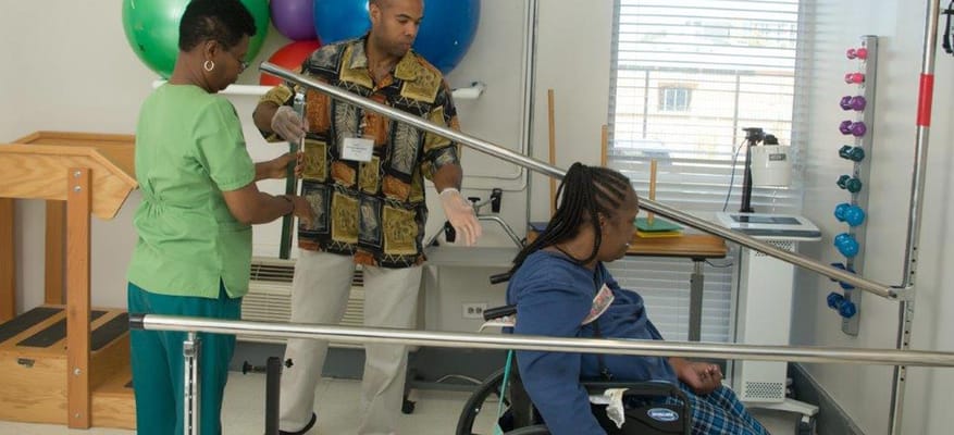 Therapist assisting resident in a rehabilitation session