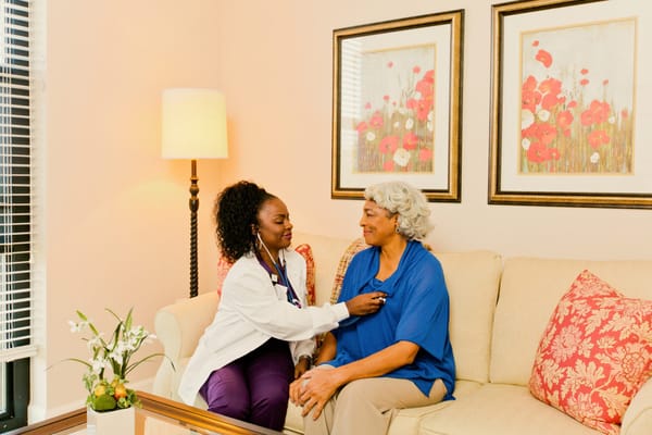 A staff member interacting with a resident in a cozy room