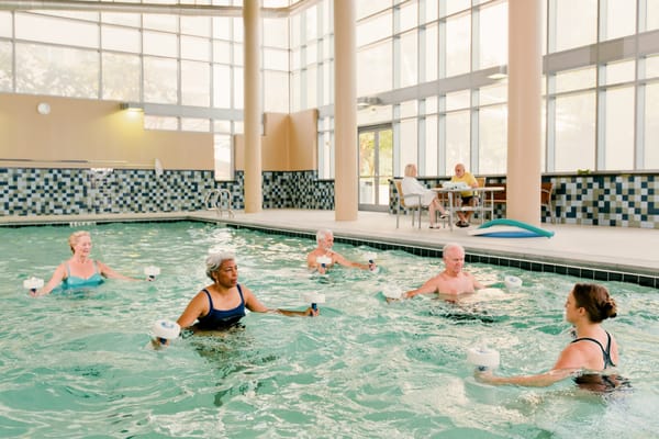 Seniors participating in an aqua fitness class in a pool