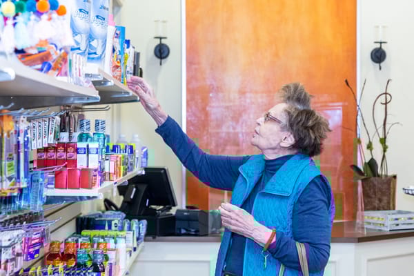 Senior woman shopping in an on-site convenience store