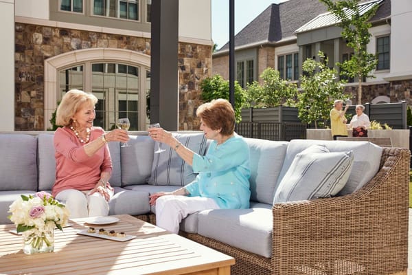 Residents celebrating with drinks in an outdoor lounge