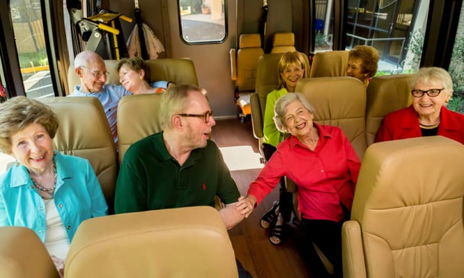 Seniors enjoying a ride in a shuttle bus