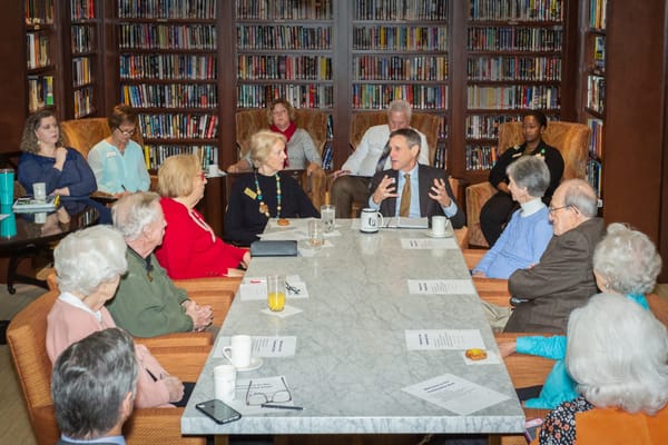 Residents engaged in discussion in a common area