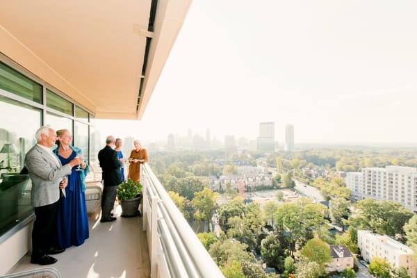 Residents enjoying a sunny outdoor balcony with city views