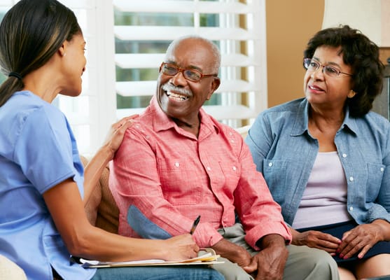 Residents engaged in a conversation with staff member