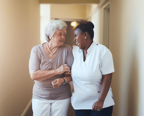 Staff member and resident having a joyful conversation