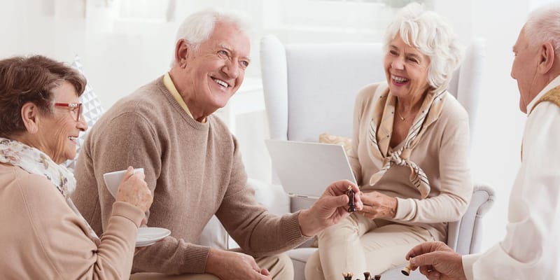 Residents enjoying a game of chess in a cozy lounge