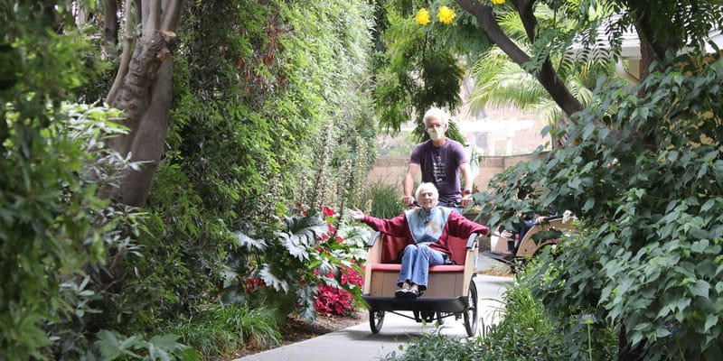 Resident enjoying a stroll in a lush garden