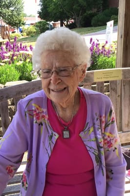 Senior woman smiling in a garden setting