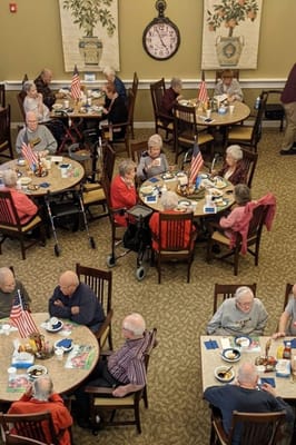 Residents dining together in a lively common area